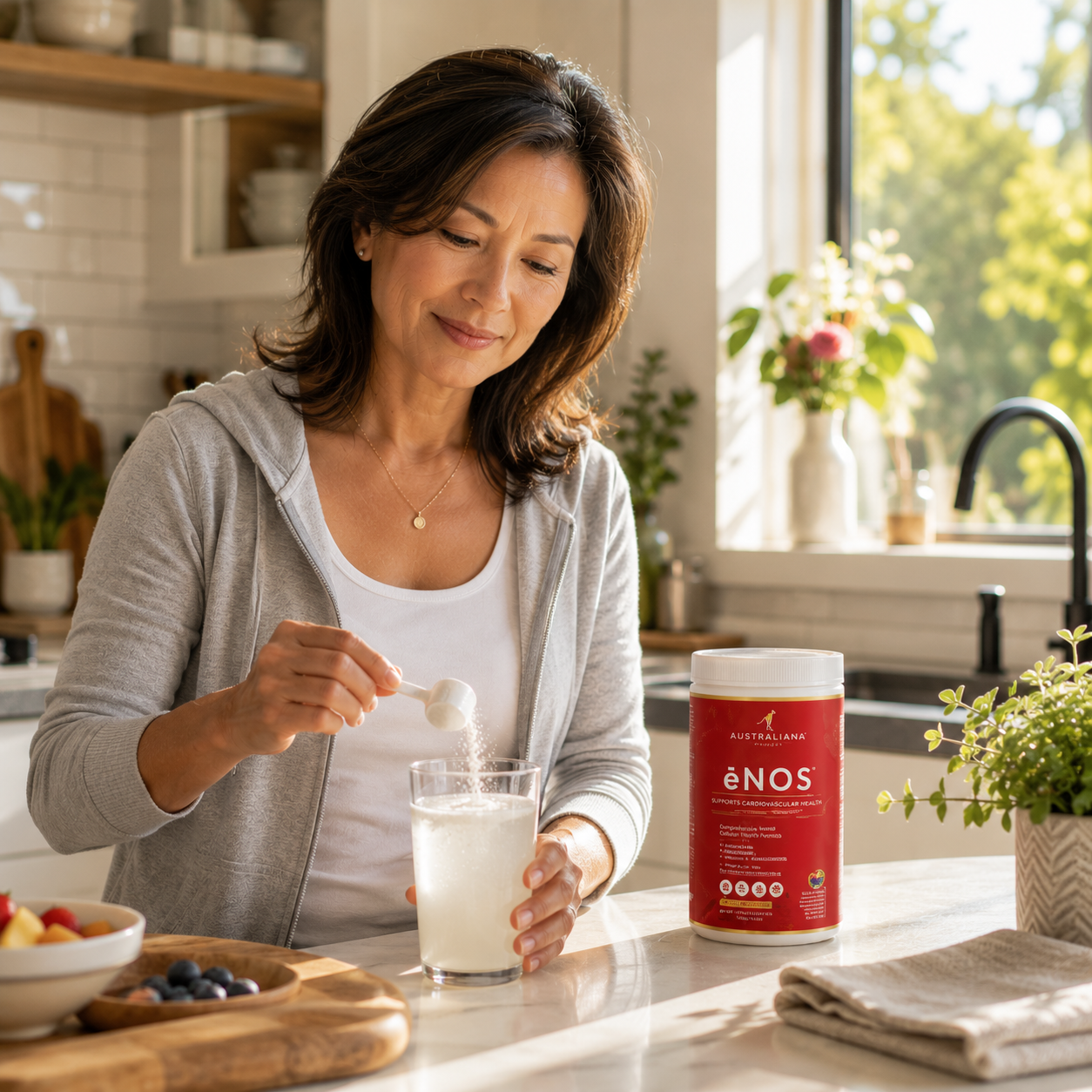 A woman mixing a scoop of ėNOS into a glass of water
